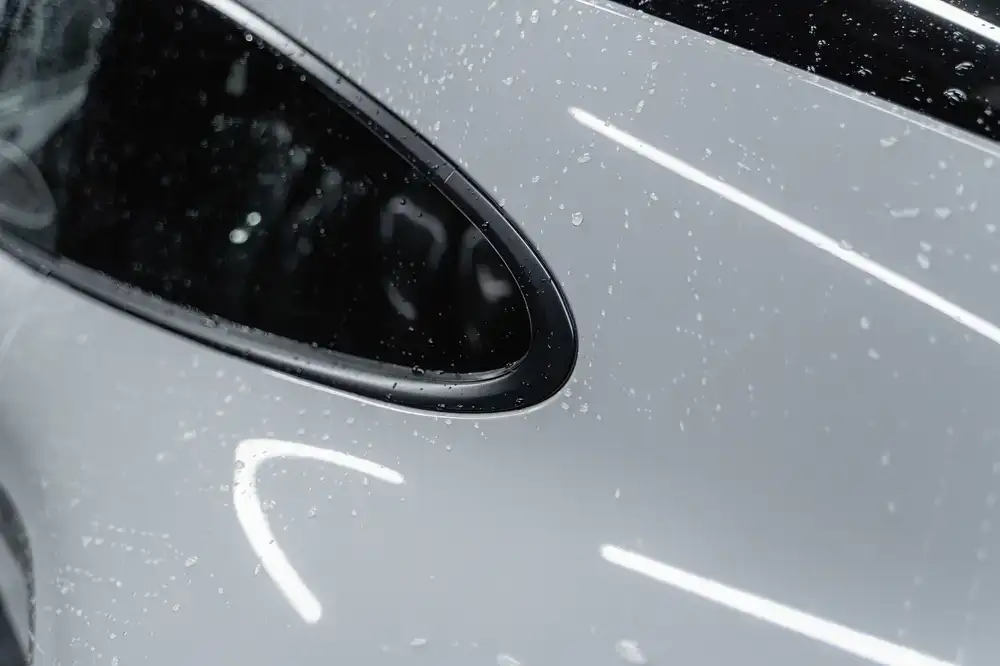 A highly polished sports car showing extreme gloss from a fresh ceramic coating application