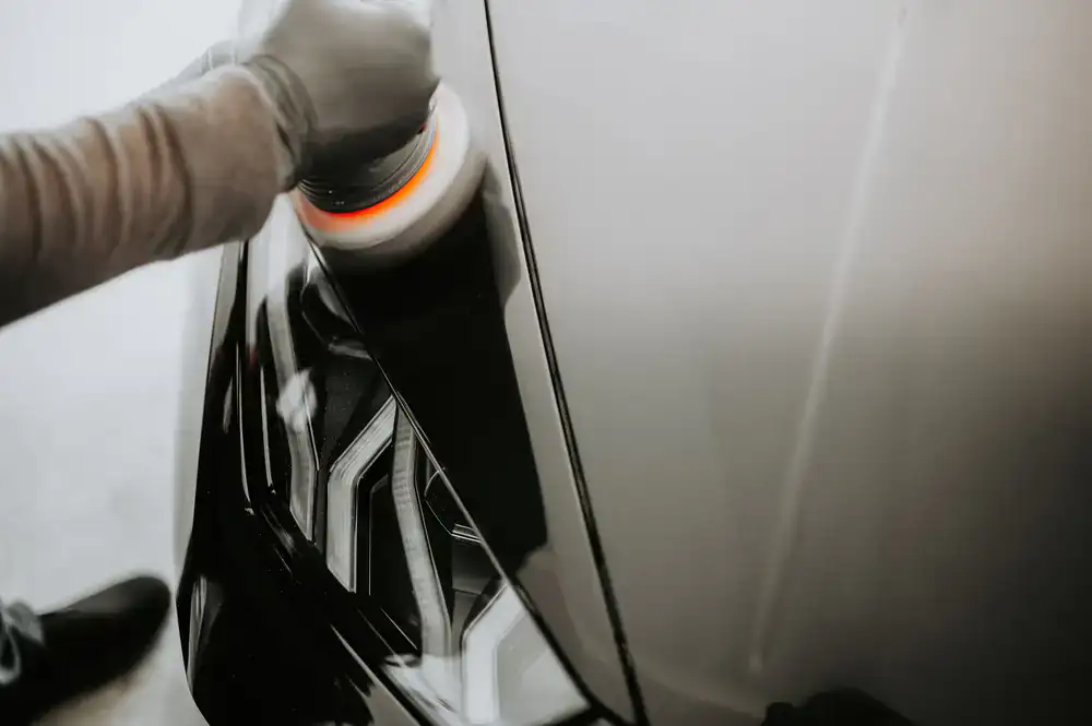 Perfectly corrected car paint reflecting the studio